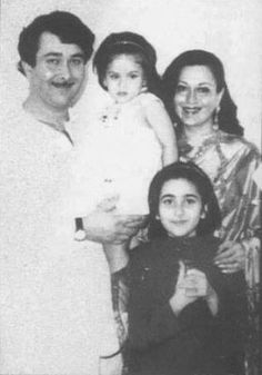 an old black and white photo of a family posing for the camera with one child