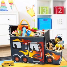 a child's storage bin with toys in it on the floor next to a toy firetruck