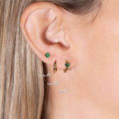 Overview: This earring set features a contemporary mix of styles: Huggie hoop and stud earrings, crafted from 14k gold. The hoop and stud earrings boast lab-created emerald gemstones, making them a perfect choice for those born in May (emerald birthstone). The versatile design allows for wear in multiple piercings including lobe, conch, cartilage, helix, and tragus, making this set ideal for everyday accessorizing or creating a trendy, curated ear look. This captivating earring set features the Hypoallergenic Hoop Jewelry For Birthday, Hypoallergenic Hoop Jewelry For Birthdays, May Birthstone Round Hoop Earrings For Pierced Ears, May Birthstone Round Hoop Earrings, 14k Gold Birthstone Hoop Earrings, Dainty Hoop Earrings With May Birthstone, Dainty May Birthstone Hoop Earrings, Dainty May Birthstone Hoop Jewelry, Minimalist May Birthstone Earrings