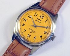 Vintage HMT Janata yellow California dial Indian Hand Winding Mens Wrist watch mechanical stainless steel gift for men for him This restored vintage watch has undergone professional cleaning, polishing, servicing, and oiling and is now ready to use  . Watch case diameter is 35mm without the crown and the lug size is 18mm . The watch features a new aftermarket dial, hands and band/strap, while retaining its original case and movement. . Provided pictures are an integral part of the item descripti Yellow Watch With Subdials And Round Dial, Modern Yellow Watch With Metal Dial, Antique Yellow Gold Analog Watch, Vintage Yellow Analog Watch, Luxury Yellow Watches With Metal Dial, Steel Gifts, Mechanical Watch, Wristwatch Men, Watch Case