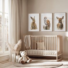 a baby's room with two pictures on the wall and a stuffed animal in the crib