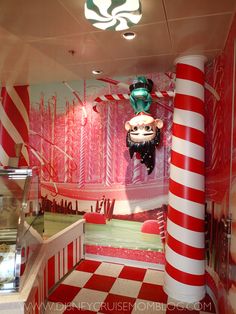 the inside of a candy shop with red and white striped walls