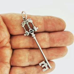 a person holding a silver key in their hand