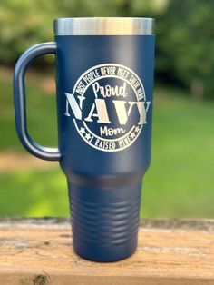 a blue travel mug sitting on top of a wooden table