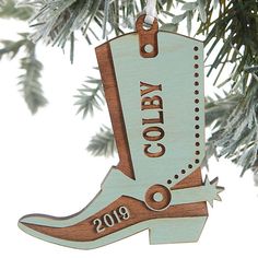 a cowboy boot ornament hanging from a christmas tree