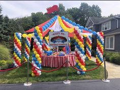 a circus tent decorated with balloons and streamers