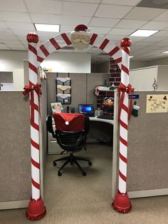 an office cubicle decorated for christmas with candy canes