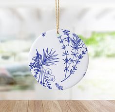 a blue and white ornament hanging from a wooden table