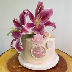 a white cake with pink flowers on top