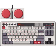 a computer keyboard with two red buttons on the front and one black button on the back