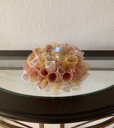 a glass table topped with a vase filled with flowers