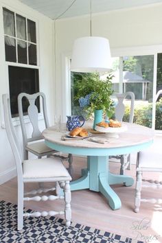 a dining room table with two chairs around it