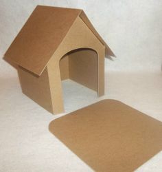 a cardboard dog house next to a mouse