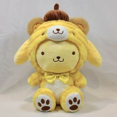 a yellow stuffed animal with a hat on its head