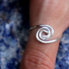 a woman's hand with a silver ring on it