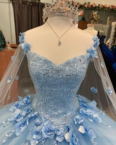 This exquisite Ball Gown Light Blue Quinceanera Dress features delicate 3D floral embellishments for a look of elegant sophistication. A timeless design crafted with superior fabrics, it is sure to delight the most discerning quinceañera. Parade the elegant and stunning side wearing this light blue ballgown. The whole ensemble is designed with 3D floral embellishments as the fitted bodice showcases a sweetheart neckline. The side capes in sheer tulle fabric add a whimsical touch. From the basque Lavender Prom Dress Long, Light Blue Quinceanera Dresses, Baby Blue Quinceanera, Blue Quinceanera Dress, Gown Sleeves, Cheap Quinceanera Dresses, Lavender Prom Dresses