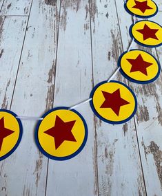 a string of red and yellow stars on a white wooden floor