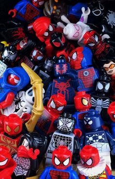 a pile of spiderman toys sitting on top of a table