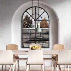 a dining room table with chairs and a bowl of lemons on it in front of an arched window