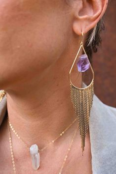 Our most popular crystal fringe statement earrings now come with Amethyst crystals. These unique tassel earrings look stunning when the light dances off of them! They are the perfect bridal or bridesmaids earrings or would make a great gift for yourself or a girlfriend. Amethyst is a stone of intuition, connecting you to your inner wisdom, empowering you to trust yourself! Amethyst crystals *color of purple amethyst is lighter purple and ranges in lightness Gold fringe earrings Weight: .22 oz Dr Elegant Purple Tassel Earrings, Fringe Dangle Chandelier Earrings, Wedding Jewelry With Tassels, Dangle Shape, Elegant Purple Tassel Earrings For Party, Purple Dangle Jewelry With Tassels, Purple Dangle Tassel Jewelry, Bohemian Dangle Crystal Earrings For Wedding, Elegant Fringe Jewelry For Weddings, Elegant Fringed Jewelry For Weddings