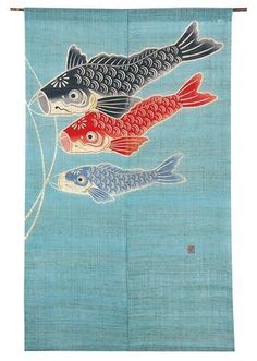 two fish on a blue background hanging from a wall