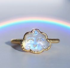 Rainbow moonstone clouds with little smiling faces are electroformed with your choice of copper, ultra thick tarnish free 14k gold or fine silver, creating a super cute kawaii style crystal ring. Each ring is made by hand and electroformed for 12 hours, allowing a unique copper design to develop and encase the stone. Rings are then buffed, polished and sealed with a protective layer to maximize luster, keep the bright and clean rose gold tone, and prevent potential tarnishing and skin discolorat Cloud Jewelry, Kawaii Ring, Cloud Ring, Rainbow Moonstone Jewelry, Rainbow Ring, Face Ring, Copper Design, Smiling Faces, Rainbow Rings