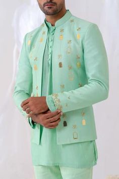 Mint green full sleeve jodhpuri with gold khidki applique embroidered motifs and cutpipe embellishment. Paired with kurta and aqua marine pant pyjama.
Components: 3
Pattern: Embroidery, Embellished
Type Of Work: Cutpipe
Neckline: Mandarin collar
Sleeve Type: Full sleeves
Fabric: Jodhpuri and Kurta: Chanderi Silk, Pant Pyjama: Cotton Linen
Color: Green
Other Details: 
Kurta Closure: Front buttons
Disclaimer: The fabrics used, are handwoven, hence may have impurities or slubs/variation in the weav Green Jodhpuri, Boys Dresses, Wedding Kurta, Wedding Kurta For Men, Kids Shirts Design, Indian Groom Wear, Men Fashion Photo, Mens Sherwani, Kurta Men