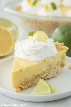 a slice of key lime pie on a plate with a fork and spoon in the foreground