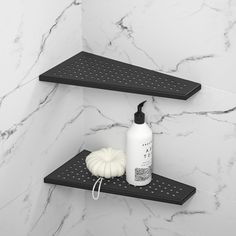 two black shelves in the corner of a bathroom