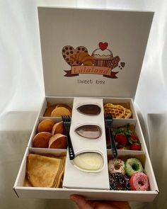 a box filled with lots of different types of donuts and pastries in it