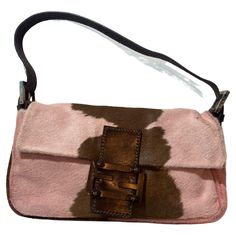 Vintage Fendi late 1990’s calfskin shoulder baguette bag. Features the rare pink and brown cow print allover, adjustable leather strap with Fendi branded hardware buckles, iconic Fendi leather and metal front flap with magnetic closure and inner zip back pocket. In excellent vintage condition. Brand: Fendi Color: Pink Brand: Fendi Fabric: Pony Hair, Leather Year / Season: Circa 1990 Authenticity Guaranteed Measurements when laid flat: Length: 10 inches, Width: 1.5 inches, Handle Drop: 8 inches Fendi Baguette Vintage, Brown Cow Print, Pink Cow Print, Ruffles Bag, Fendi Vintage, Purple Quilts, Brown Cow, Vintage Fendi, Pink Cow