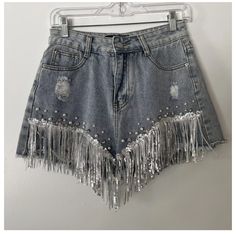 Denim Distressed Shorts From Shop Michella, Perfect For Any Cowgirl Or Western-Themed Occasion. The Shorts Feature A 5-Pocket Design And Button And Zip Closure, With Accents Such As Pearls, Fringe, Rhinestones, And Sequins. Medium Wash. New, With Tags. Perfect Condition. Trendy High Waist Jean Shorts For Parties, Trendy Jean Shorts For Party, Trendy Summer Party Jean Shorts, Party Jean Shorts For Spring, Summer Party Cutoff Bottoms, Spring Party Jean Shorts, Party-ready Jean Shorts For Spring, Party Cutoff Denim Shorts, Spring Cutoff Jean Shorts With Rhinestone Fringe