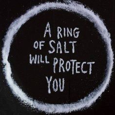 a ring of salt will protect you written in white chalk on a blackboard background