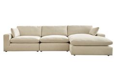 a large sectional couch with pillows on the top and bottom corner, in beige linen