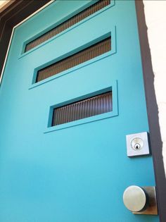 a blue door with two round knobs on it