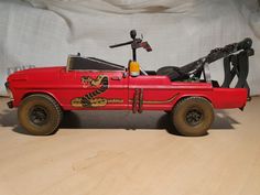 a red toy car with a dragon painted on the side