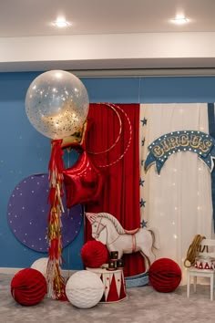 balloons, streamers and decorations are on display in a room decorated for a birthday