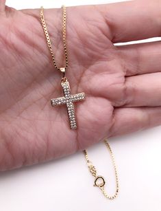 "Cubic Zirconia Cross Necklace Beautiful Cross 18k gold plating with zirconia encrusted. The cross measures 1.2 x 0.75 inch or 3 x 1.9 cm box 1mm chain. Details: 18K Gold Plated Pendant and chain Spring-ring clasp for closure Length 17.5\" inches or 45 cm It looks great alone or layering with other necklaces. It is carefully shipped in a beautiful organza pouch, bubble wrapped and well protected. A lot of my jewelry is made with silver plated and gold plated solid brass or any other metal. It wi Gold Cubic Zirconia Cross Pendant Necklace, Gold Cross Pendant Necklace With Diamond Accents, Gold Diamond Cut Cross Necklace, Cubic Zirconia Crucifix Jewelry Gift, Gift Cross Necklace With Diamond Accents In Cubic Zirconia, Crucifix Necklace With Vvs Clarity As Gift, Gift Crucifix Necklace Vvs Clarity, Gift Crucifix Necklace With Vvs Clarity, Gold Jewelry With Vvs Clarity Cross Pendant