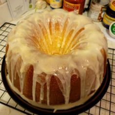 a bundt cake with icing sitting on top of a cooling rack