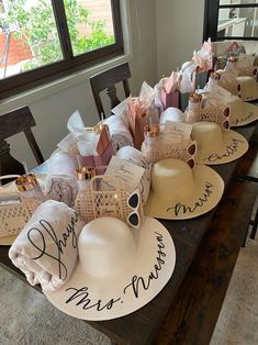 many hats are sitting on top of the table with congratulations written on them and bags in front of them