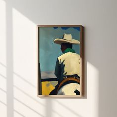 a painting hanging on the side of a wall with a man in a cowboy hat