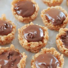 cookies with chocolate frosting are on a sheet of wax paper and ready to be eaten