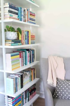 a white book shelf filled with lots of books