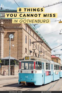 a blue and white train traveling down tracks next to a tall building with the words 8 things you cannot miss in goethenbergburg