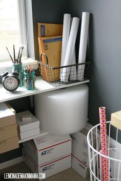 a white toilet sitting next to a window in a room with boxes on the floor