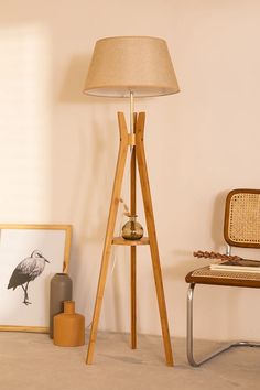 a lamp sitting on top of a wooden stand next to a chair