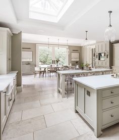 a large kitchen with an island in the middle and lots of counter space around it