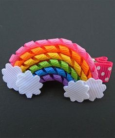 a rainbow brooch with white polka dots on it