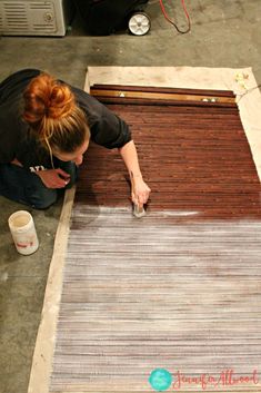 a woman is working on an area rug