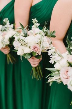 bridesmaids in green dresses holding bouquets of white and pink flowers